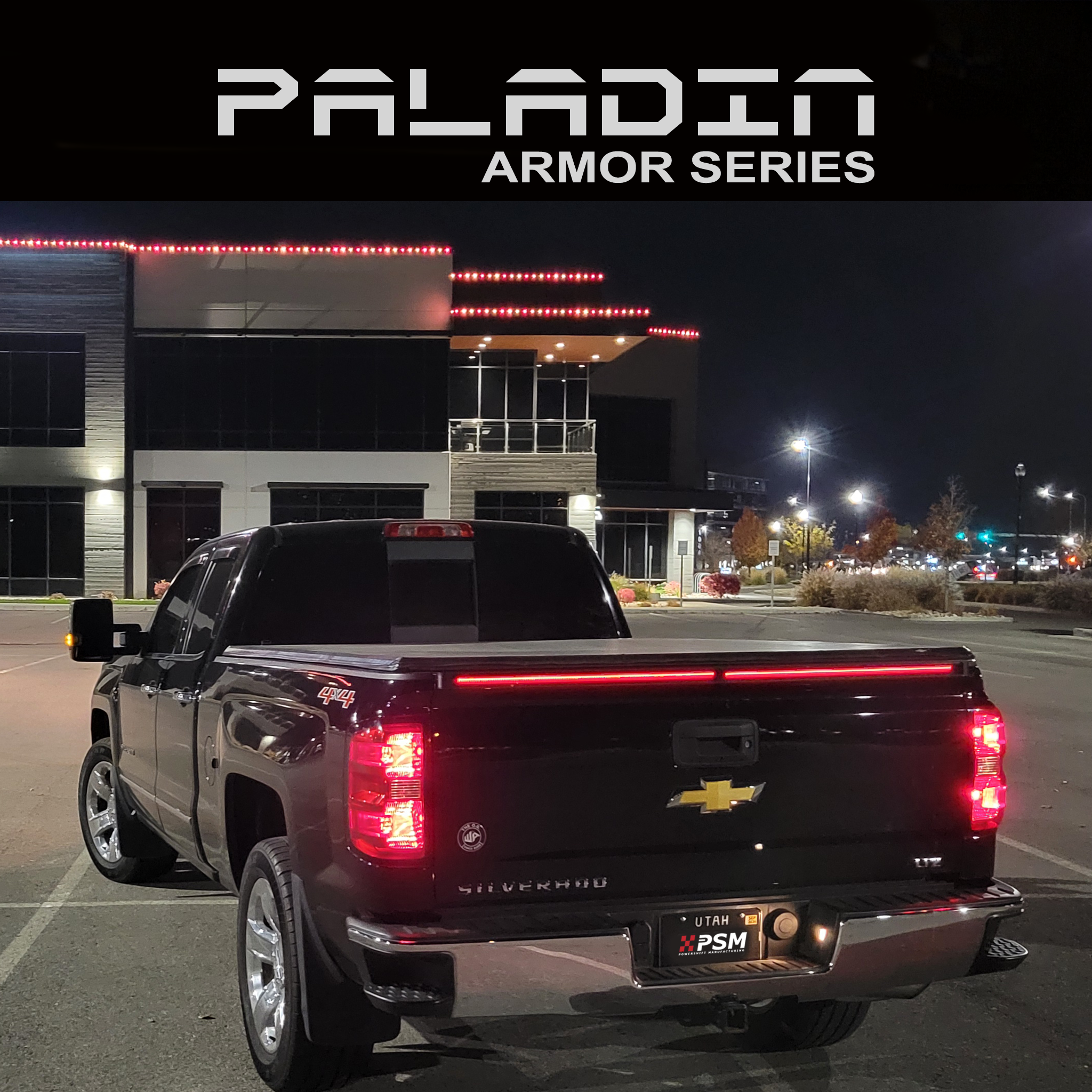 Chevy Silverado 2014–2018 at night with PSM PALADIN LED tailgate protector from the Armor series.