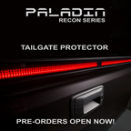 Close up PSM PALADIN LED tailgate protector on a truck tailgate in a studio with bright red high intensity LED's activated