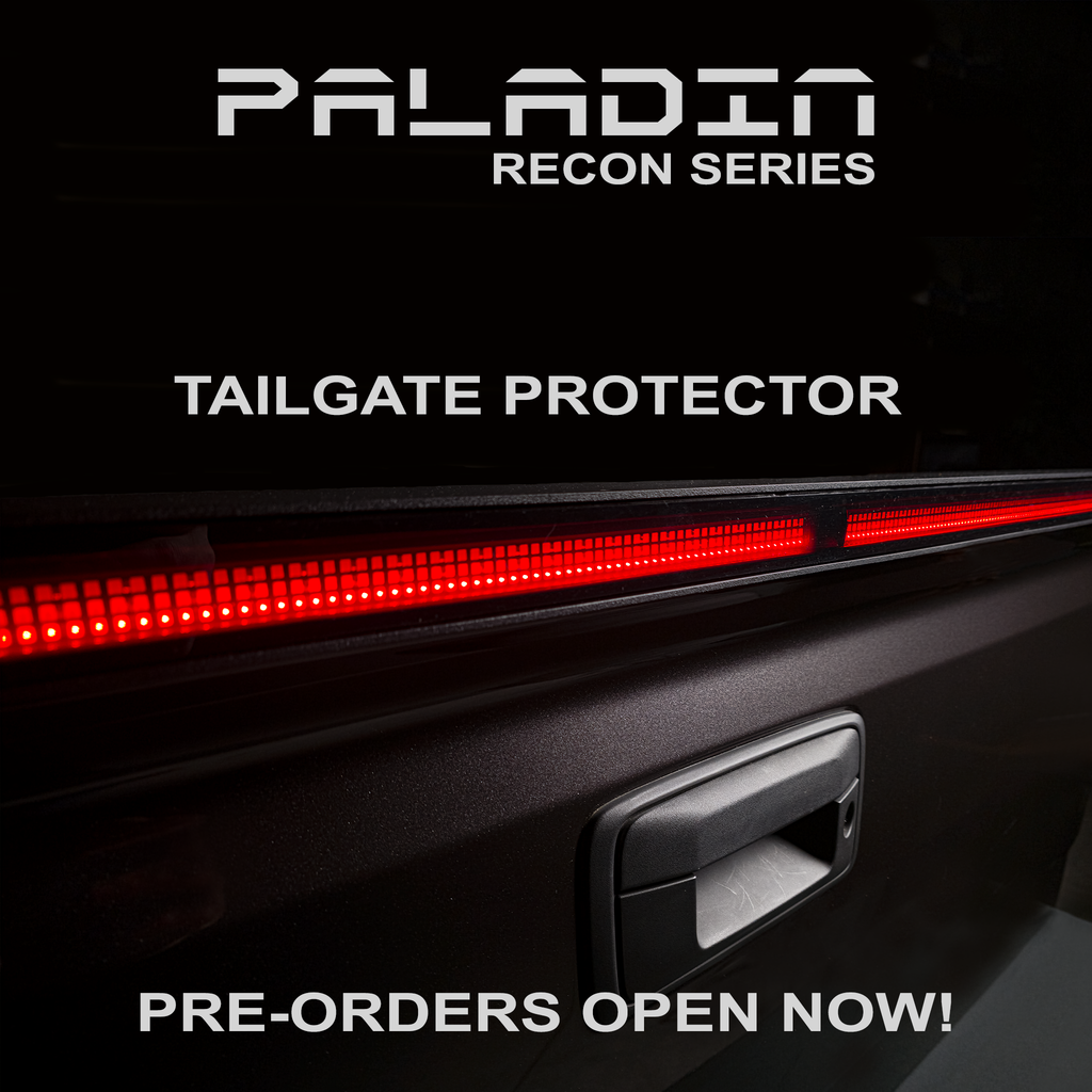 Close up PSM PALADIN LED tailgate protector on a truck tailgate in a studio with bright red high intensity LED's activated