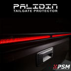 Close up PSM PALADIN LED tailgate protector on a truck tailgate in a studio with bright red high intensity LED's activated